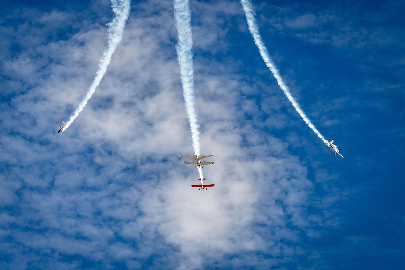 Formation of four aircraft trailing smoke over Eagles Nest